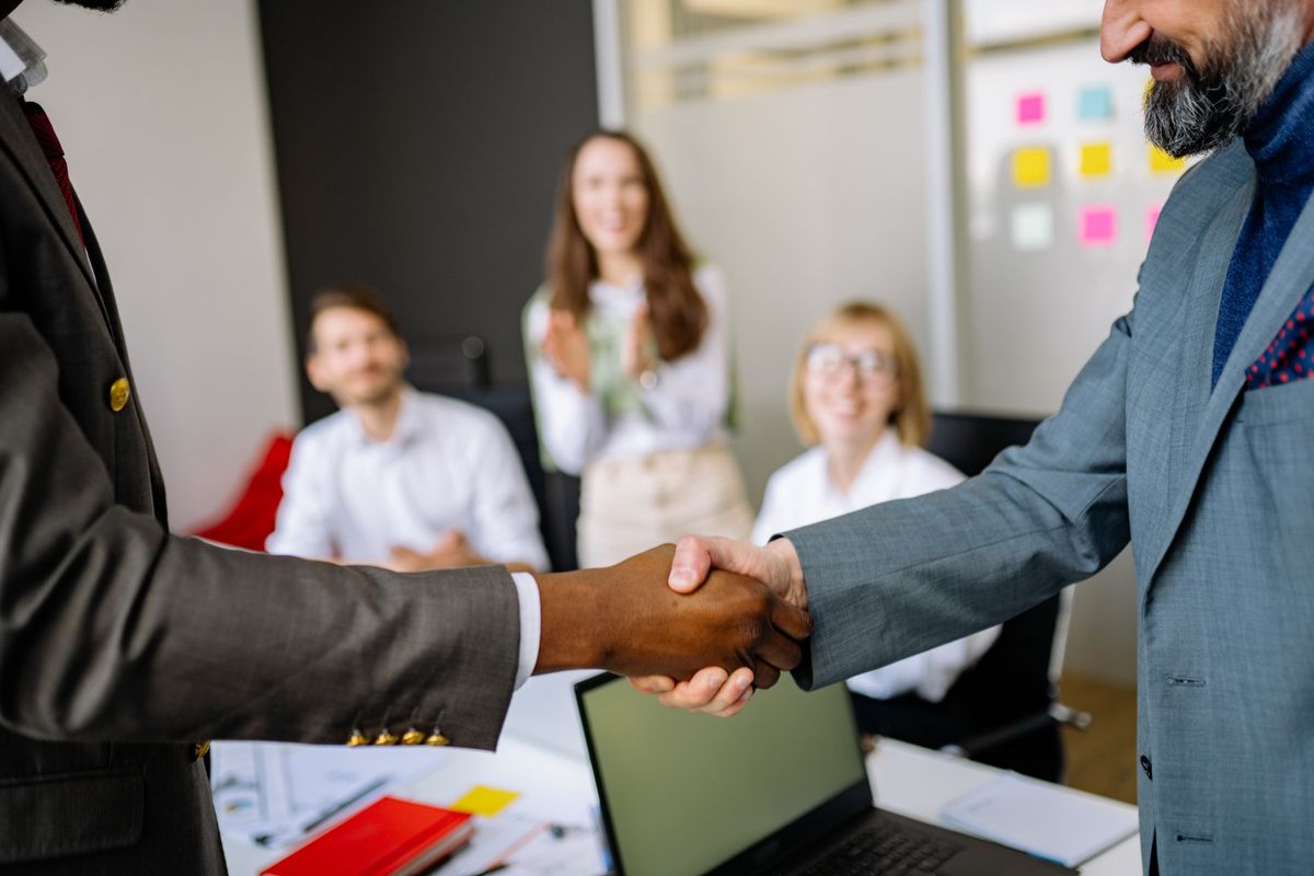 Business partnership handshake representing mutual guarantee cooperation